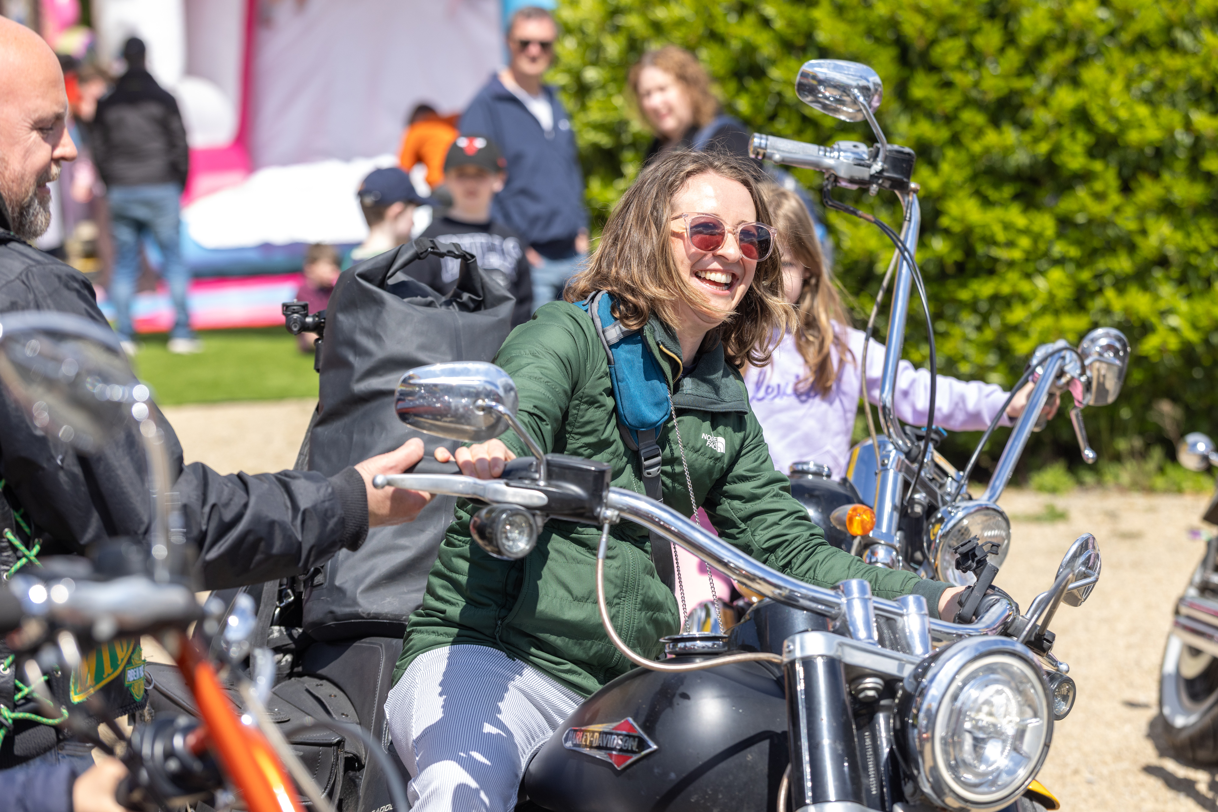 Person smiling on  motorbike. 